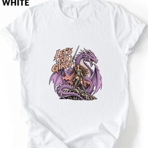 A white t-shirt with a graphic design depicting a woman standing next to a purple dragon.