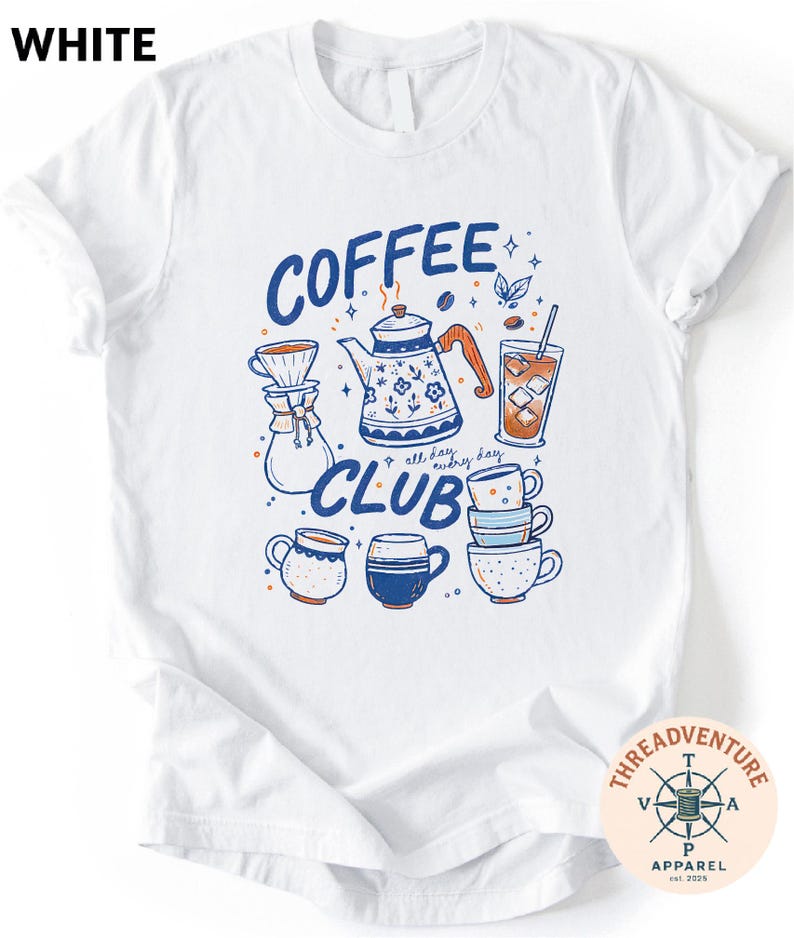 A white t-shirt with a graphic design featuring various coffee-related items such as a coffee pot, coffee cup, and iced coffee cup, along with the text "COFFEE CLUB" and other related illustrations.