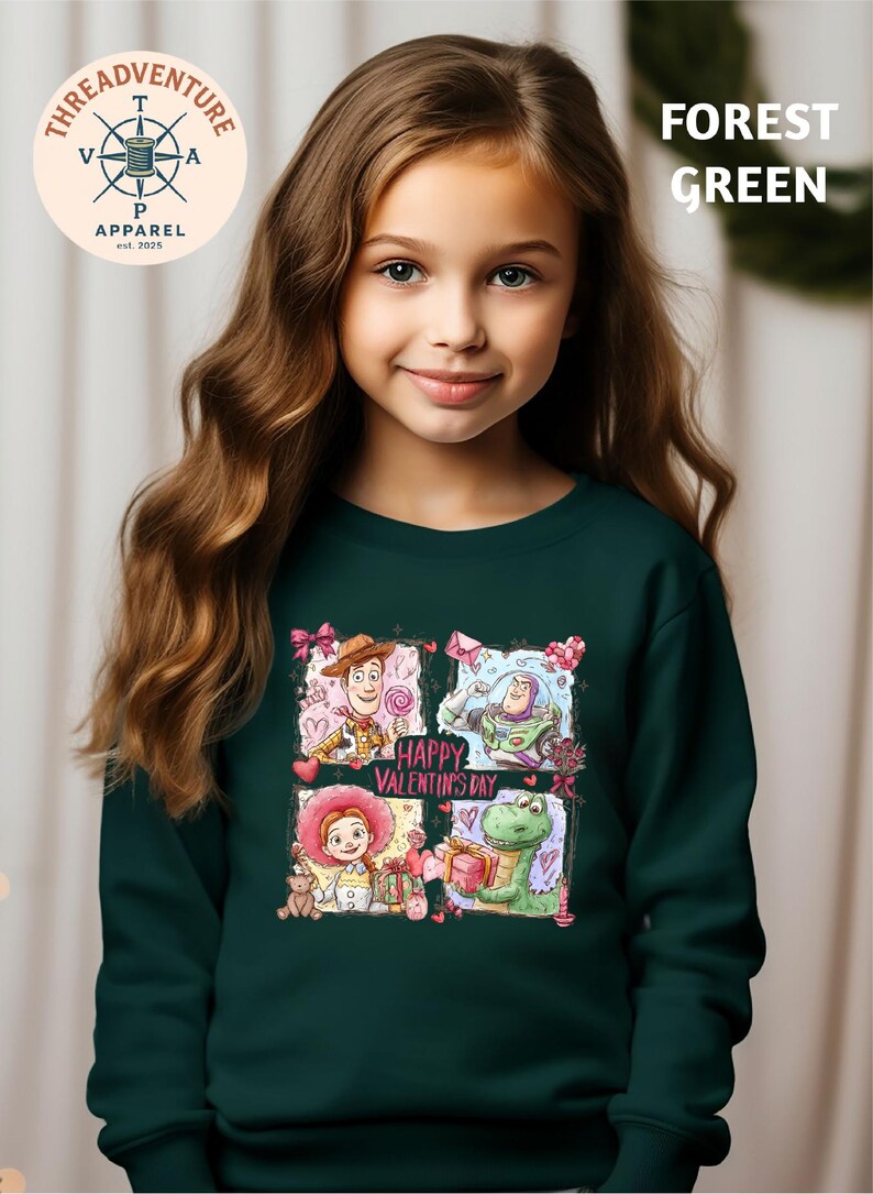 A young girl with long brown hair wearing a green sweater with a graphic design featuring characters from Toy Story.