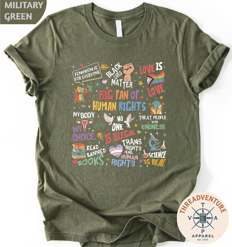The image is a t-shirt with a graphic design featuring various phrases and symbols related to LGBTQ+ rights and diversity.