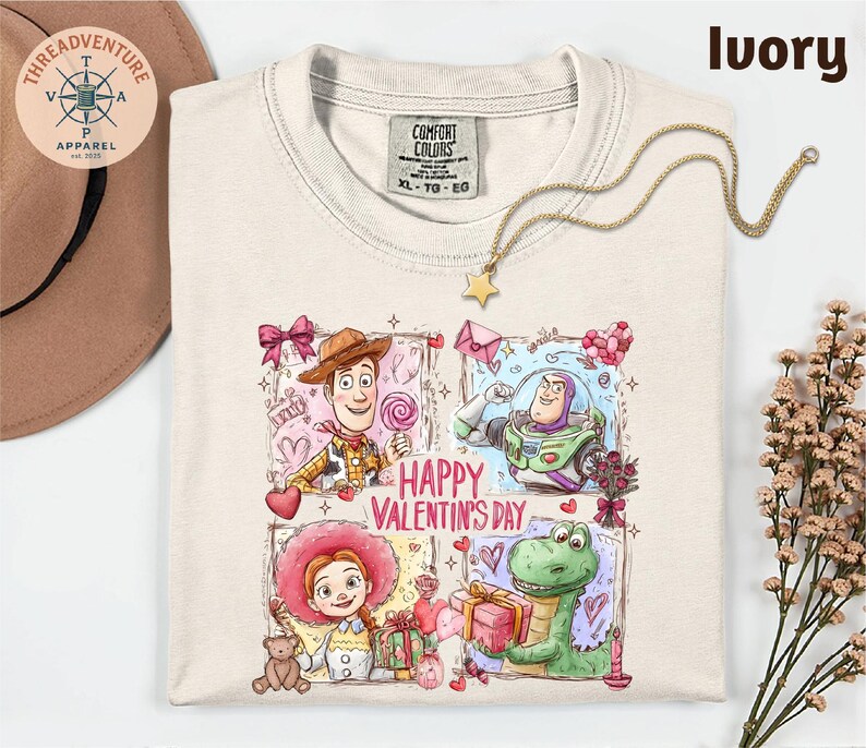 a white t-shirt with a colorful graphic design depicting characters from the Toy Story movie, including Woody, Buzz Lightyear, and a dinosaur. The design also includes the text "Happy Valentine's Day".