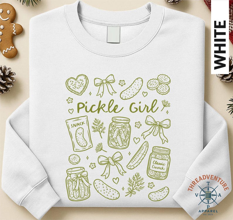 A white long-sleeved shirt with a graphic design featuring various pickle-related items such as jars, a jar of pickles, and a heart.