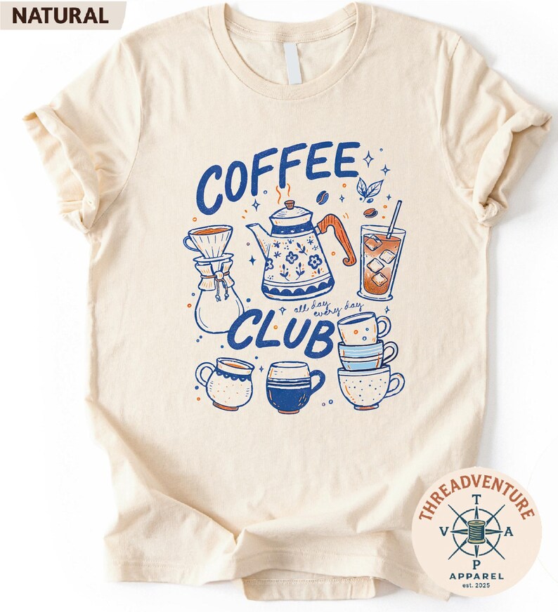 The image is a t-shirt with a graphic design featuring various coffee-related items such as a coffee pot, coffee cup, and coffee mug, along with the text "COFFEE CLUB" and the phrase "all every day".