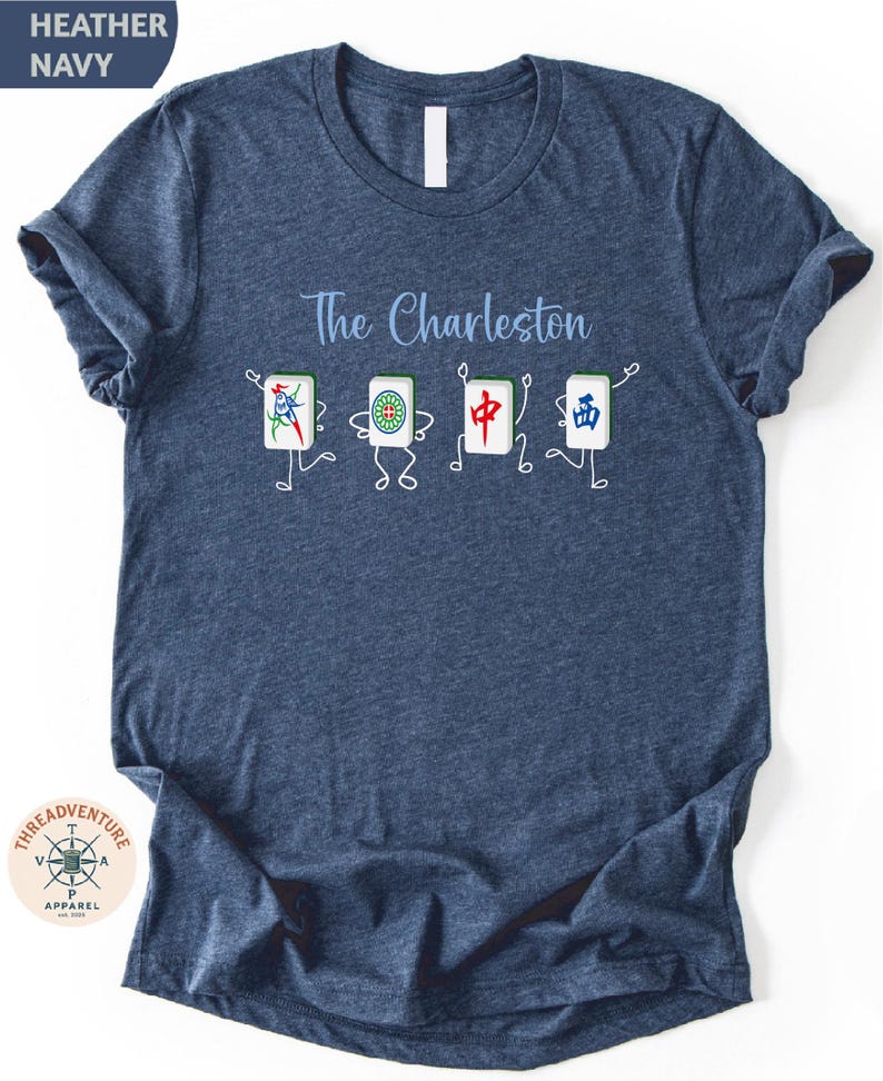 A blue t-shirt with a graphic design featuring four cartoon-like characters and the text "The Charleston" printed on it.