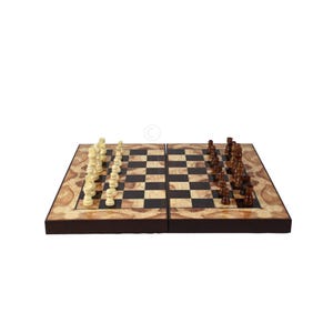 May include: A folding wooden chessboard featuring a polished finish with a swirling light brown grain pattern on the border. The board is set with a full complement of light cream-coloured pieces on one side and dark brown pieces on the other.