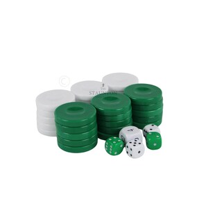 May include: A set of game pieces including stacks of white and green circular checkers and four six-sided dice. Two dice are white with black pips and numbers, while two are green with white pips. The text The Staunton is visible on a piece.