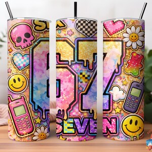 May include: A colorful tumbler with a straw, featuring a vibrant design with the number "67" and the word "SEVEN". The design includes a skull, hearts, smiley faces, daisies, a gummy bear, and a cell phone. The background has a glittery effect.
