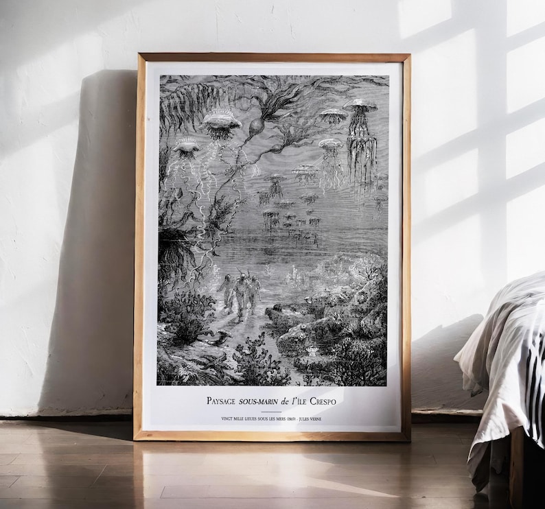 May include: Black and white framed print of an underwater scene with jellyfish and figures. The artwork features detailed illustrations of marine life and a vintage aesthetic. The text at the bottom reads "Paysage Sous-Marin de l'Ile Crespo".