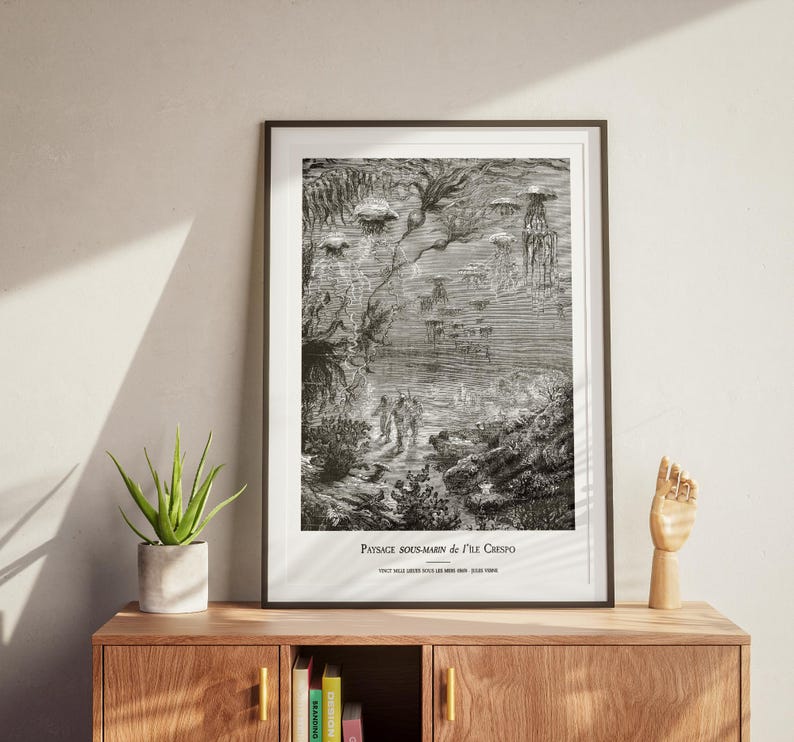 May include: Black and white framed print of an underwater scene with figures and marine life. The artwork features detailed illustrations of jellyfish, coral, and other aquatic elements. The text at the bottom reads "PAYSAGE SOUS-MARIN de l'&Icirc;le Crespo".