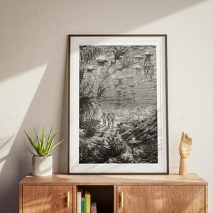 May include: Black and white framed print of an underwater scene with figures, jellyfish, and aquatic plants. The detailed illustration depicts a vintage, fantastical environment with a sense of depth and mystery. The artwork is displayed on a wooden cabinet.