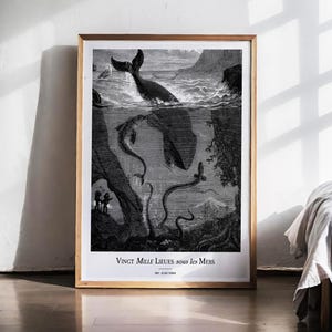 May include: Framed black and white print depicting a whale breaching the water's surface, with an underwater scene of sea creatures and a whale. The print includes the text "Vingt Mille Lieues sous les Mers", a vintage illustration.
