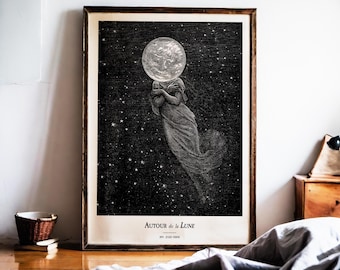 May include: A framed black and white print featuring a celestial theme. The artwork depicts a figure with a moon for a head, floating in a starry night sky. The text "AUTOUR de la LUNE" is printed at the bottom.