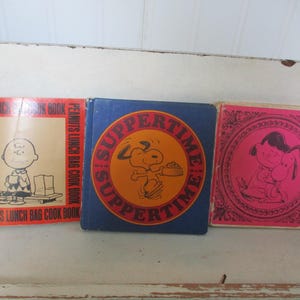 Children's books / comics lot of 3 by Charles Schulz Happiness is a Warm Puppy, Suppertime! and Peanut's Lunch Bag Cook Book 1st printing