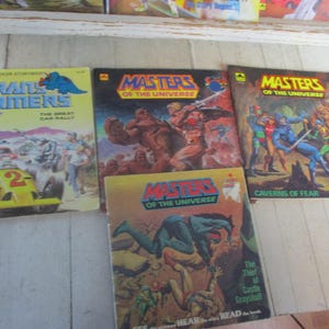 Lote de 7 libros infantiles vintage de los años 80 Go-Bots, Transformers, Masters of the Universe, cómics, gráficos