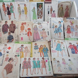May include: A collection of vintage sewing patterns, featuring illustrations of dresses, coats, and other garments. The patterns are from brands like Butterick, Simplicity, McCall's, and Vogue. The covers display colorful drawings of the clothing designs.