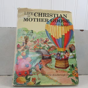 May include: A white ceramic mug with a black handle and the text "But First, Coffee" in a black, bold font. The mug is on a white surface. The mug is approximately 4 inches tall.