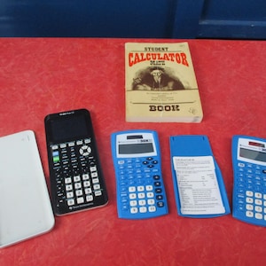 Lot 3 Texas Instrument Calculators and Student Calculator Math Book 1980 2 TI-30XIIS 1 TI-84 Plus CE 2 blue power on TI84 isn't charged