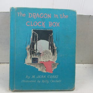 May include: A white ceramic mug with a black handle and the text "But First, Coffee" in a black, handwritten-style font. The mug is on a white surface.