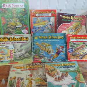 May include: A collection of eight The Magic School Bus children's books featuring colorful illustrations of the iconic yellow school bus in various settings including the rain forest, ocean floor, and inside the earth, with Scholastic branding.