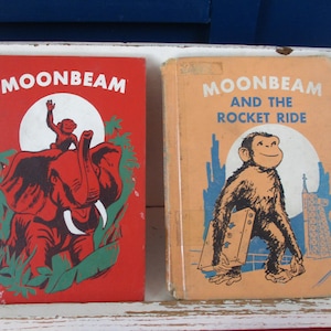 May include: Two vintage children's books. The book on the left is red with the title "Moonbeam" and an illustration of an elephant and monkey. The book on the right is orange with the title "Moonbeam and the Rocket Ride" and a monkey illustration.