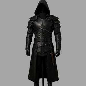 May include: Black leather hooded costume with studded accents. The costume features shoulder pads, a belted waist, and a long coat. The sleeves have studded gauntlets, and the outfit includes gloves. A medieval or fantasy-themed garment.