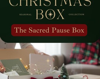 May include: A Christmas Box Collection with the text "CHRISTMAS BOX COLLECTION" and "The Sacred Pause Box". The box contains a candle, a mug with "CHOOSE JOY" text, a small Christmas tree, and a gift box.