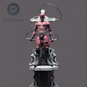 May include: A red Daredevil action figure stands atop a detailed gray pedestal. The figure is in a dynamic pose, holding two batons and a whip. The figure is wearing a textured red suit with black accents.