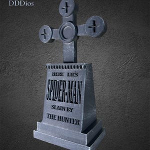 May include: A gray tombstone with a cross-shaped top. The tombstone reads "HERE LIES SPIDER-MAN SLAIN BY THE HUNTER." The design is a unique, stylized tribute to the comic book character.