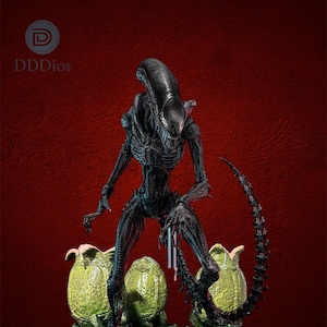May include: A detailed figurine of an Alien creature, standing tall with a long, segmented tail. The dark figure is surrounded by three green, egg-like pods on a metallic platform, set against a deep red backdrop. The figurine is a collectible item.