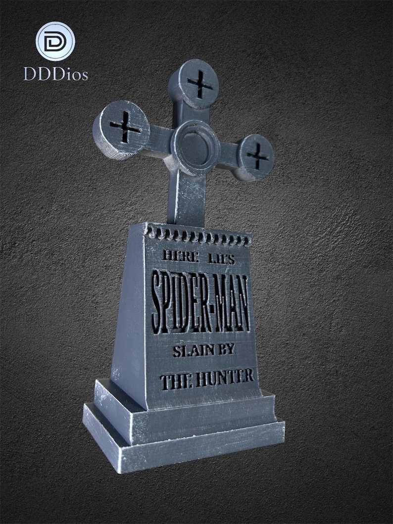 May include: A gray tombstone with a cross-shaped top. The tombstone reads "HERE LIES SPIDER-MAN SLAIN BY THE HUNTER". The logo "DDDios" is in the upper left corner. The background is a textured gray.