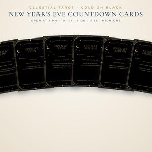 May include: Six black rectangular cards with gold celestial borders and text. The cards are labelled for New Year's Eve, with specific opening times from 9 PM to midnight. Each card features instructions for activities, including writing wishes and sharing memories.