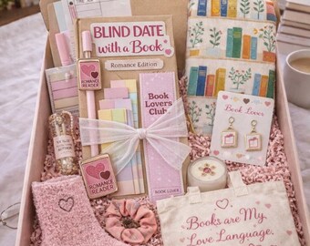 May include: A deluxe gift box containing book-related items. It features a book, socks, earrings, and a tote bag with the text "Books are My Love Language." The box is pink and filled with pink shredded paper, with a "DELUXE" label.