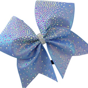 May include: A light blue cheer bow with iridescent glitter and rhinestones. The bow has a black elastic band for attaching to hair.