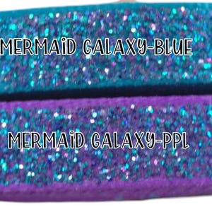 May include: Two rolls of iridescent blue glitter ribbon with the text "MERMAID GALAXY-BLUE" and "MERMAID GALAXY-PPL" printed on them.