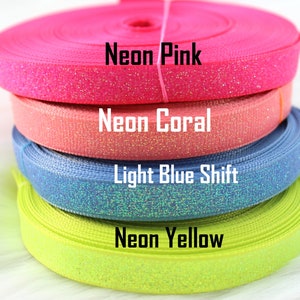 May include: Four rolls of glitter ribbon in neon pink, coral, light blue shift, and neon yellow.