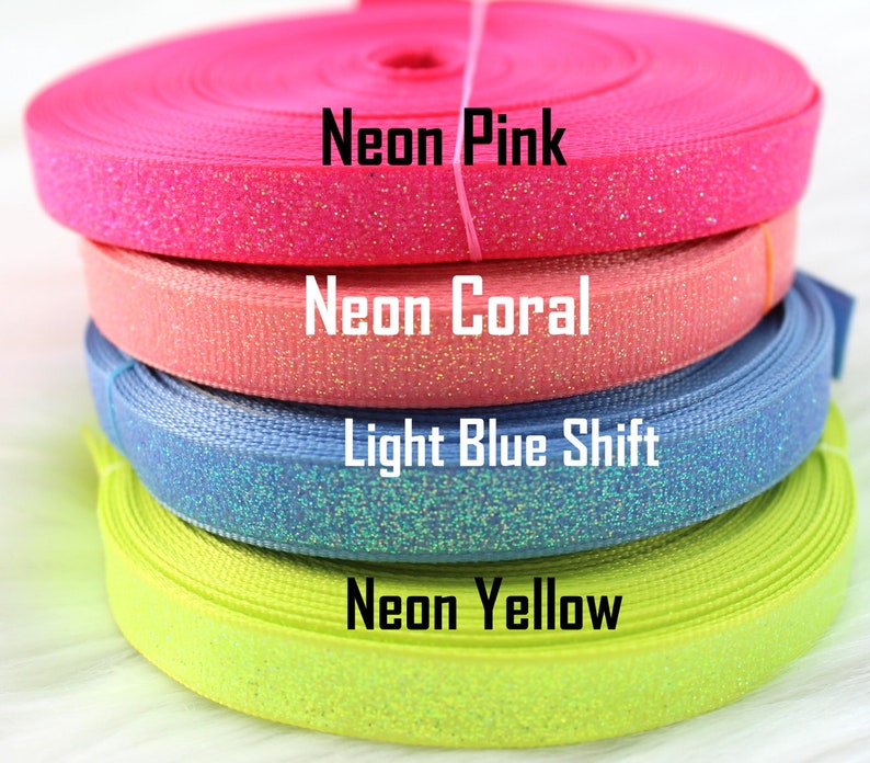 May include: Four rolls of glitter ribbon in neon pink, coral, light blue shift, and neon yellow.