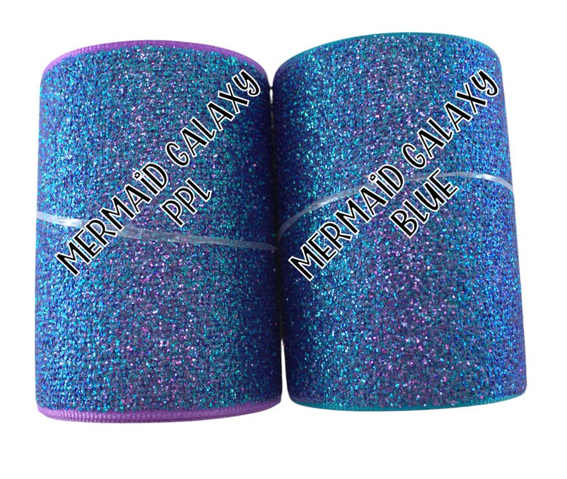 May include: Two rolls of glitter ribbon, one purple and one teal, with the text "Mermaid Galaxy" and the color name printed on each roll.