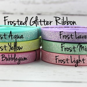 May include: Frosted glitter ribbon in six colors: aqua, yellow, bubblegum, lavender, mint, and light pink.  "Frosted Glitter Ribbon" is written at the top of the image.