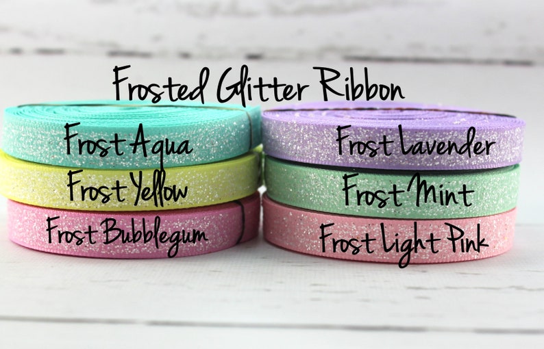 May include: Frosted glitter ribbon in six colors: aqua, yellow, bubblegum, lavender, mint, and light pink.  "Frosted Glitter Ribbon" is written at the top of the image.