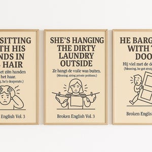 May include: Three framed art prints with humorous illustrations and text in English and another language. The prints feature line drawings and phrases like "He's sitting with his hands in his hair" and "She's hanging the dirty laundry outside."