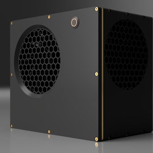 May include: A black box with a honeycomb-shaped vent on one side and a gold trim around the edges. The box has a small, round button on the top.