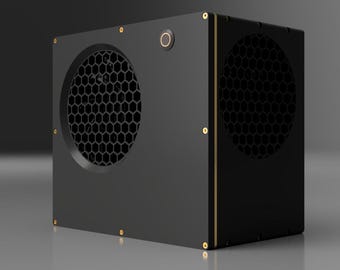May include: A black box with a honeycomb-shaped vent on one side and a gold trim around the edges. The box has a small, round button on the top.