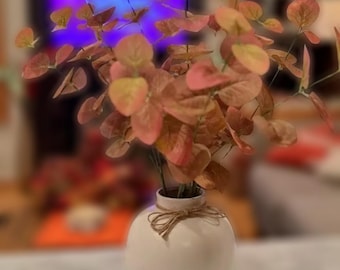 Vibrant Orange Eucalyptus in White Pottery Vase