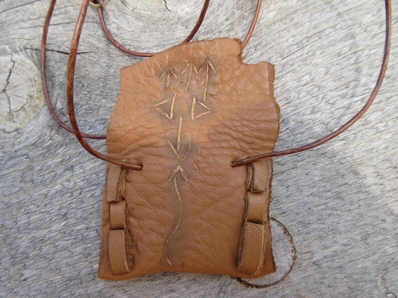 Communication...This Wisdom Pouch is made out of a warm toasty Brown Deerskin Leather and it features a hand carved symbol.
