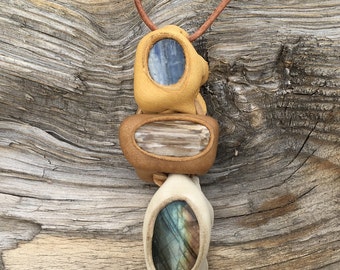Leather and Stone Amulet- Triple Moon...this Stream of Life Amulet features Blue Kyanite, Petrified Wood and Labradorite set in leather.