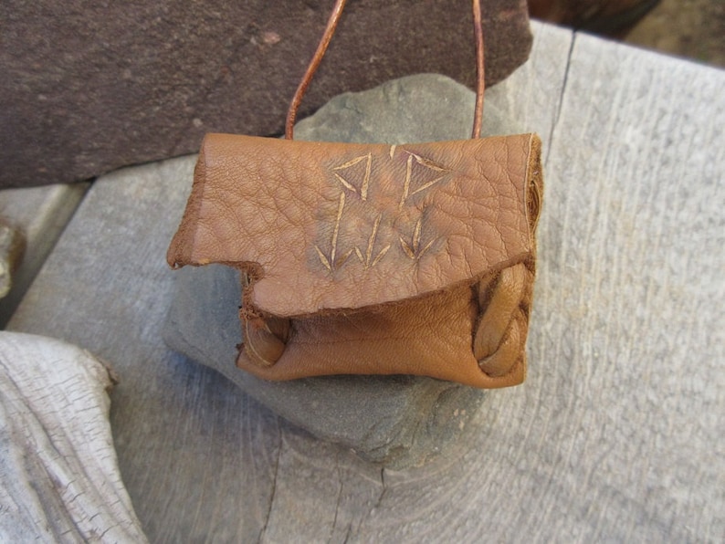 Communication...This Wisdom Pouch is made out of a warm toasty Brown Deerskin Leather and it features a hand carved symbol.