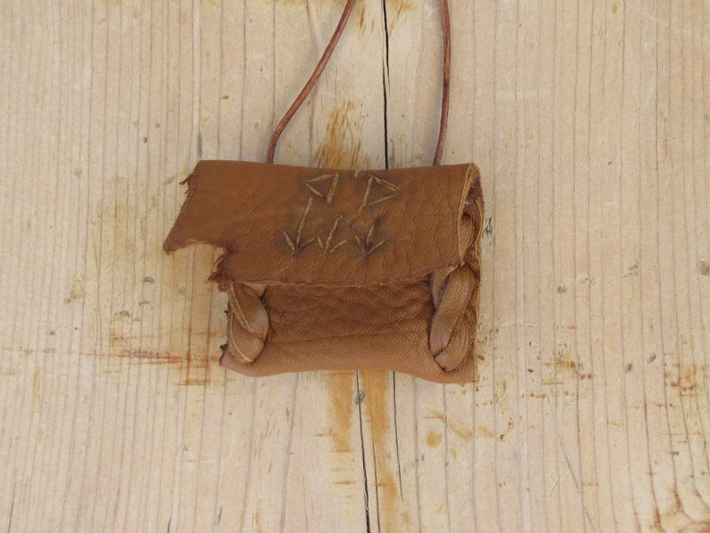 Communication...This Wisdom Pouch is made out of a warm toasty Brown Deerskin Leather and it features a hand carved symbol.