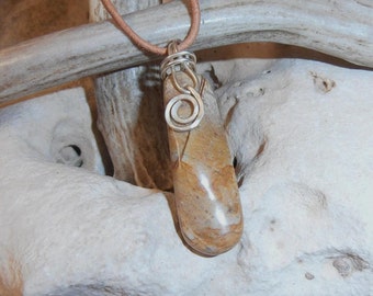 Soft Light - This Stone Talisman features a polished piece of Picasso Marble that has a Silver wire bail with a Spiral on it.