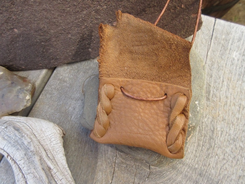 Communication...This Wisdom Pouch is made out of a warm toasty Brown Deerskin Leather and it features a hand carved symbol.