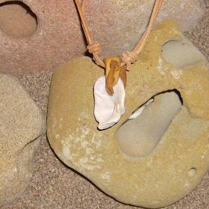 Movement This Amulet features a Water tumbled Shell fragment that has a Tan Leather bail image 3